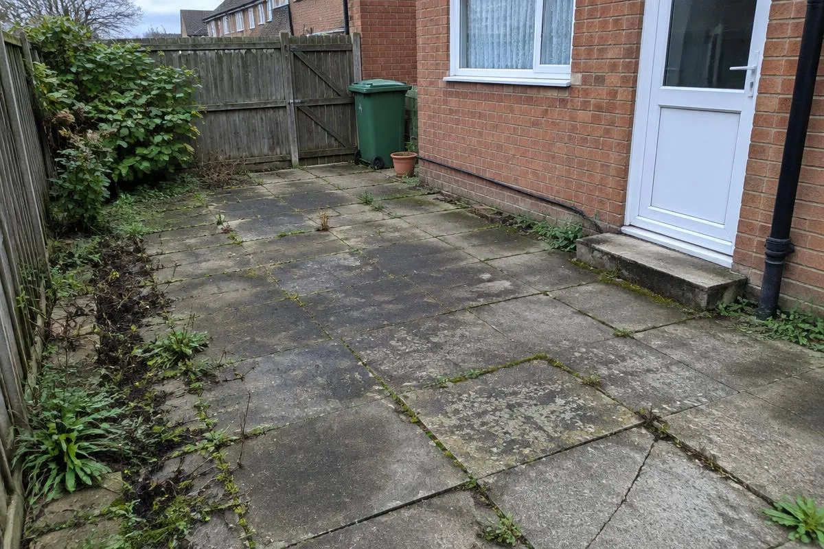 Existing worn patio before proposed improvements
